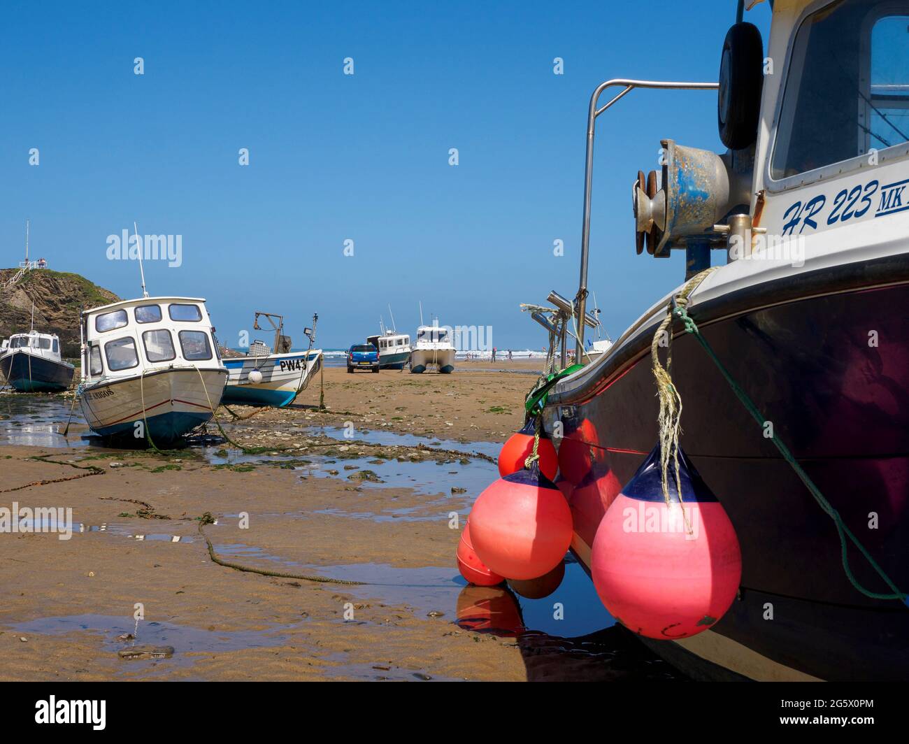 Fishing boats in a tidal harbour at low tide, Bude, Cornwall, UK Stock Photo
