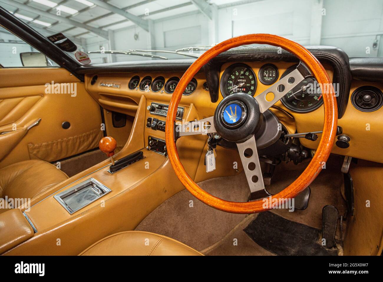 Interior view of dashboard and steering wheel in a 1971 Maserati 4700 Indy America V8 - Stock Image