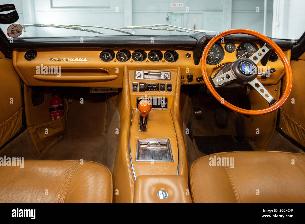 Interior view of dashboard and steering wheel in a 1971 Maserati 4700 Indy America V8 - Stock Image