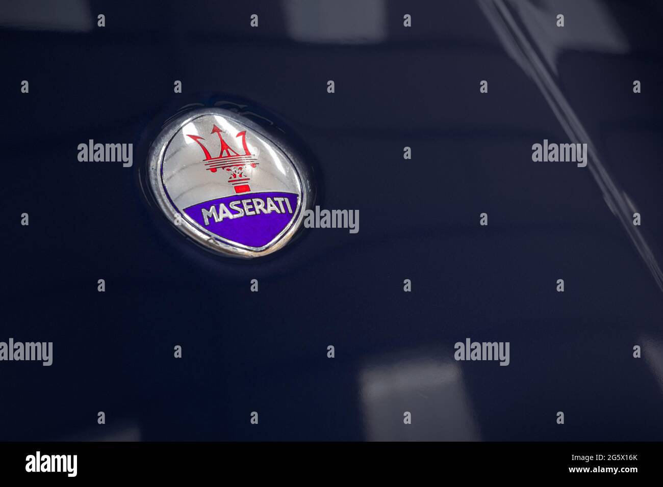 Detail of Maserati emblem on a blue 1971 Maserati 4700 Indy America V8 - Stock Image