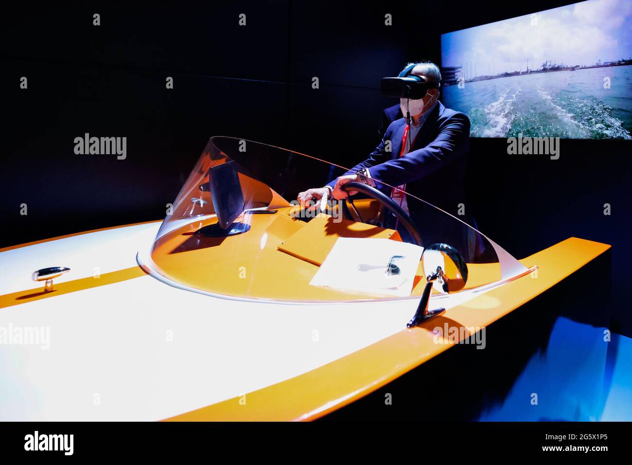 A congress visitor remotely controlling a marine drone on the Orange stand  of the Mobile World Congress, during the third day of the event. Thanks to  5G, an unmanned boat located in