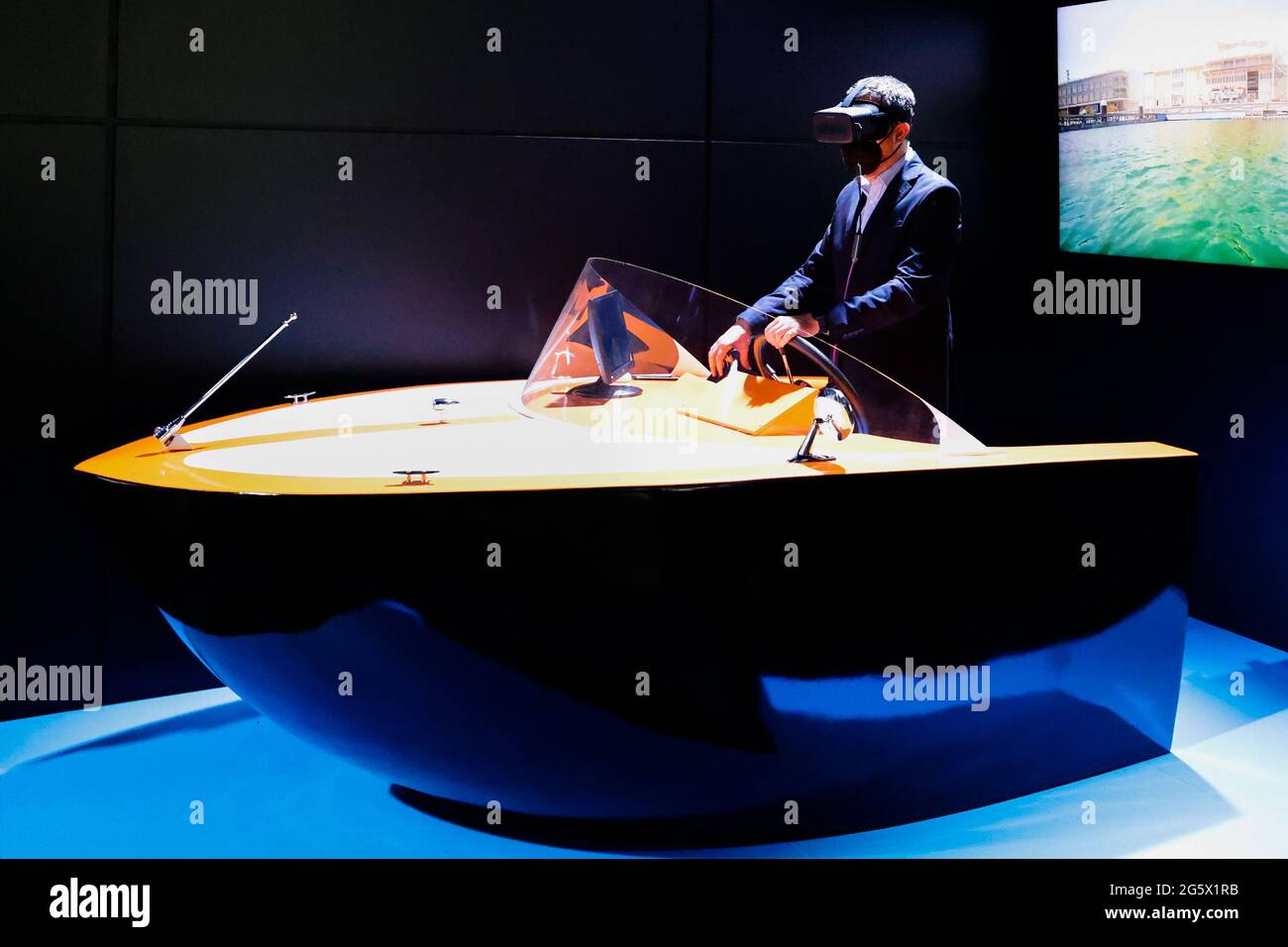 A congress visitor remotely controlling a marine drone on the Orange stand  of the Mobile World Congress, during the third day of the event. Thanks to  5G, an unmanned boat located in