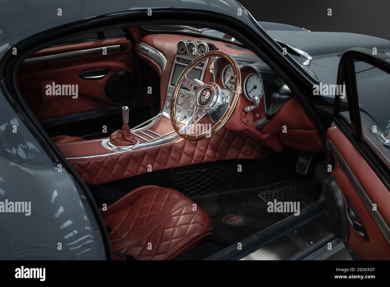 View of red interior of a grey 2018 Dowsetts Comet 6.2 V8 sports car - Stock Image