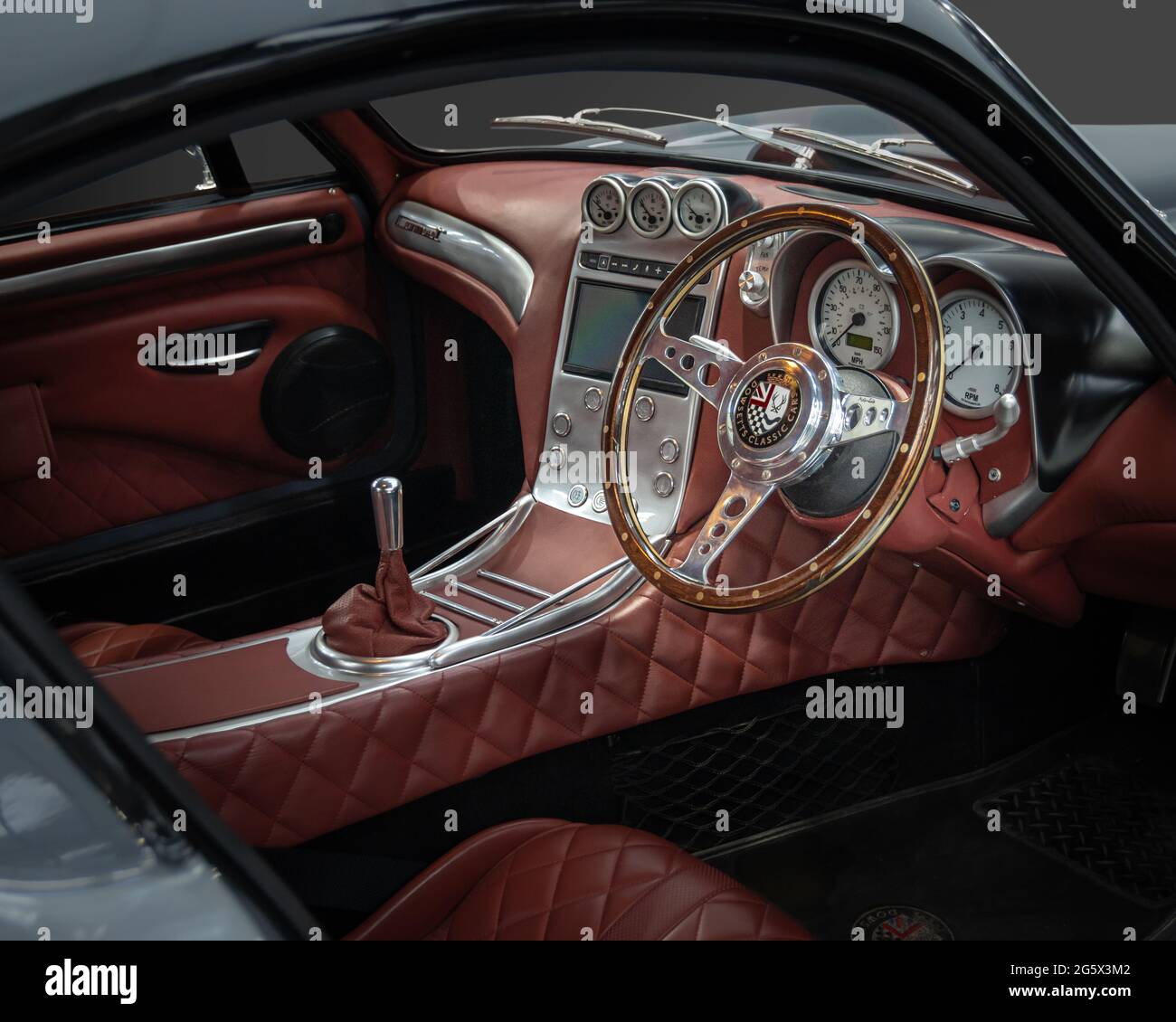 View of red interior of a grey 2018 Dowsetts Comet 6.2 V8 sports car - Stock Image
