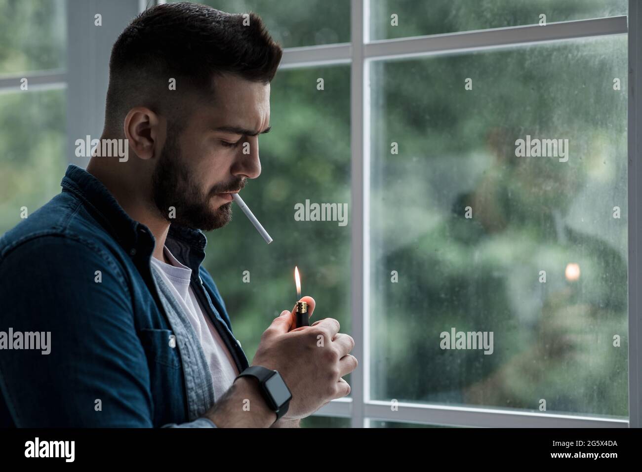 Urban lifestyle, emotional portrait of young handsome man sad and depressed, smoking Stock Photo