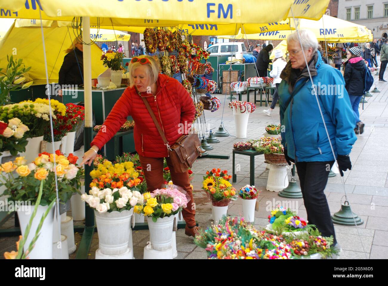 Two ladies shopping for flowers, Market Square, Krakow, Poland Stock Photo