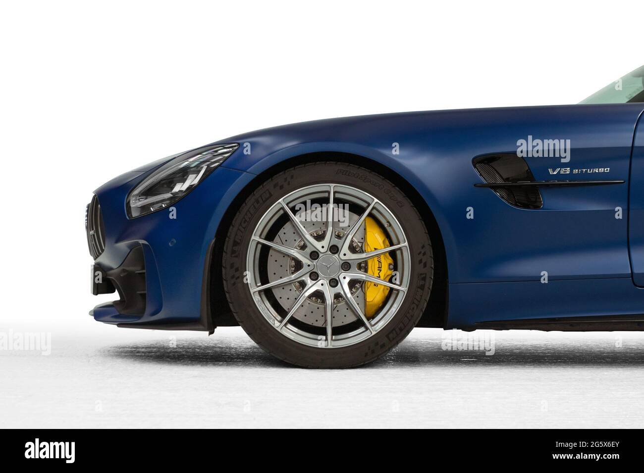 Detail showing front profile of car with alloy wheel with brake disc and calliper on a blue 2021 Mercedes AMG GTR V8 Biturbo - Stock Image