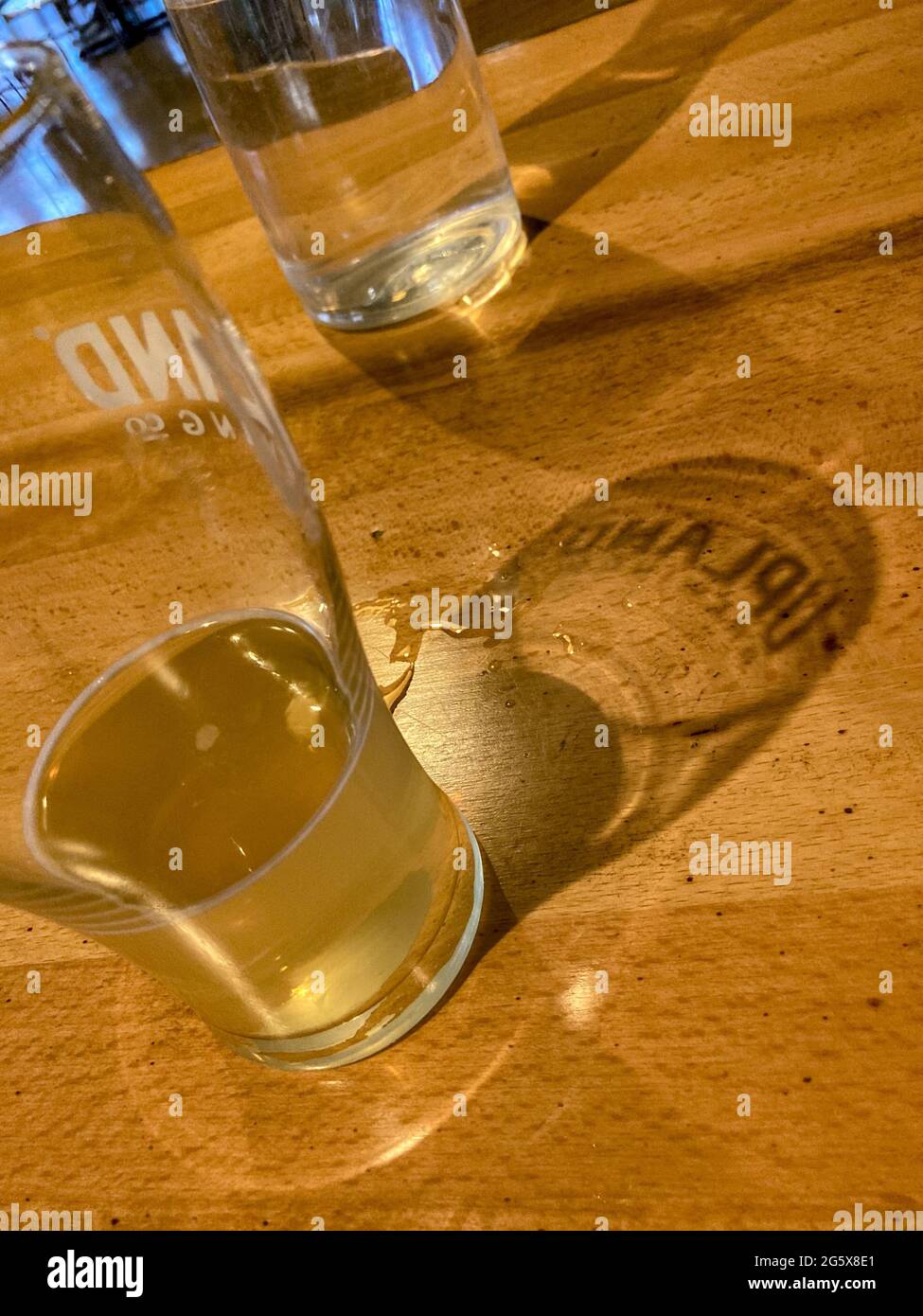 Half Empty beer glass and shadow Stock Photo