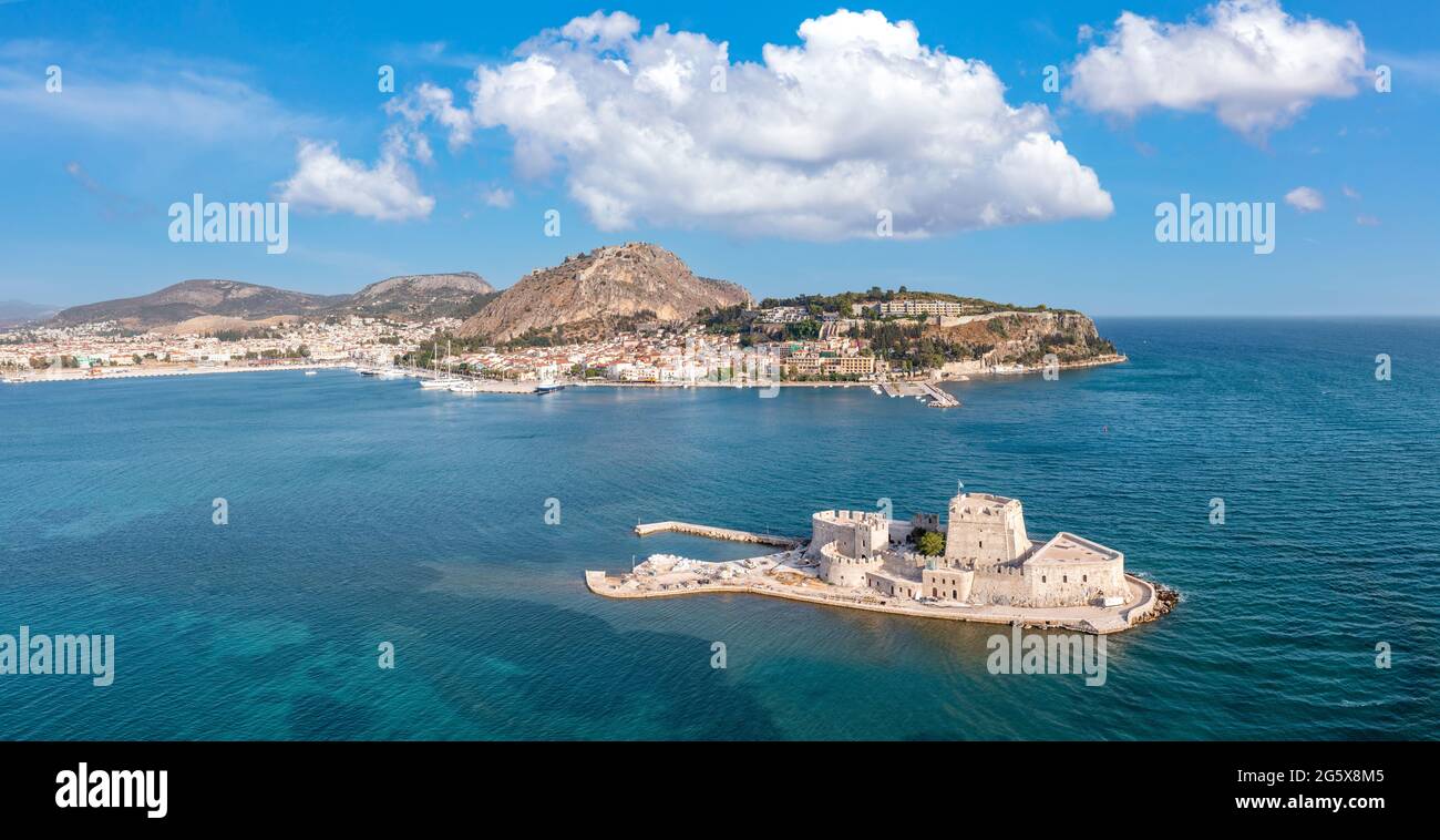 Greece, Nafplio city and Bourtzi, Venetian water fortress at the entrance of the harbour. Aerial drone view. Peloponnese old town cityscape, Blue sky Stock Photo