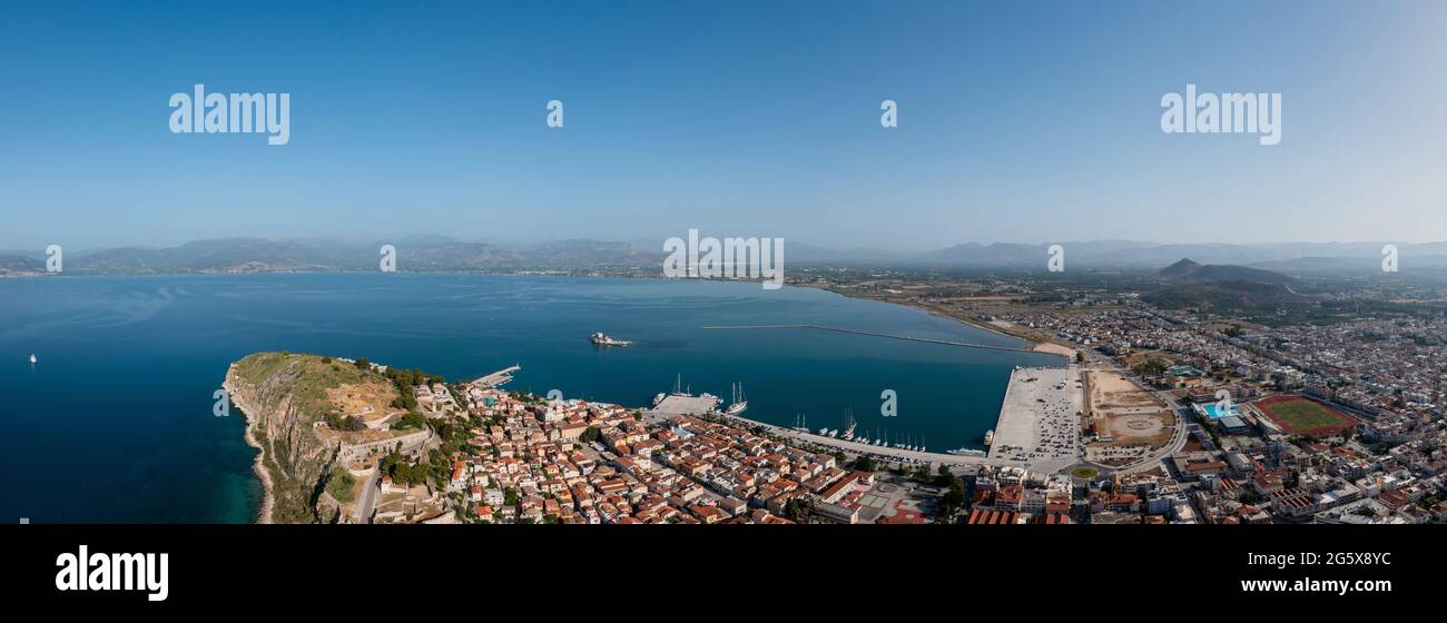 Greece, Nafplio city and harbor, Aerial drone panoramic view. Peloponnese old town cityscape, and BourtziVenetian water fortress at the entrance of th Stock Photo