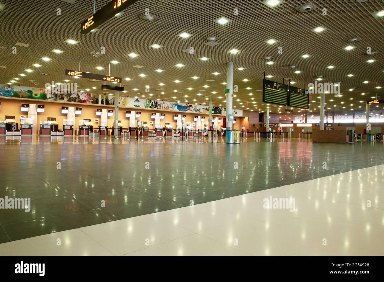 airport check in desk and airport empty from no one flying due to coronavirus Stock Photo