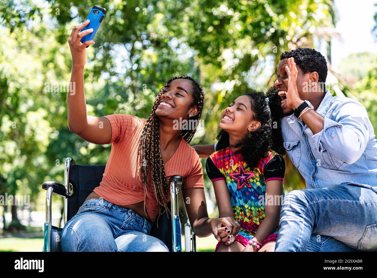 Woman in a wheelchair taking a selfie with her family Stock Photo - Alamy