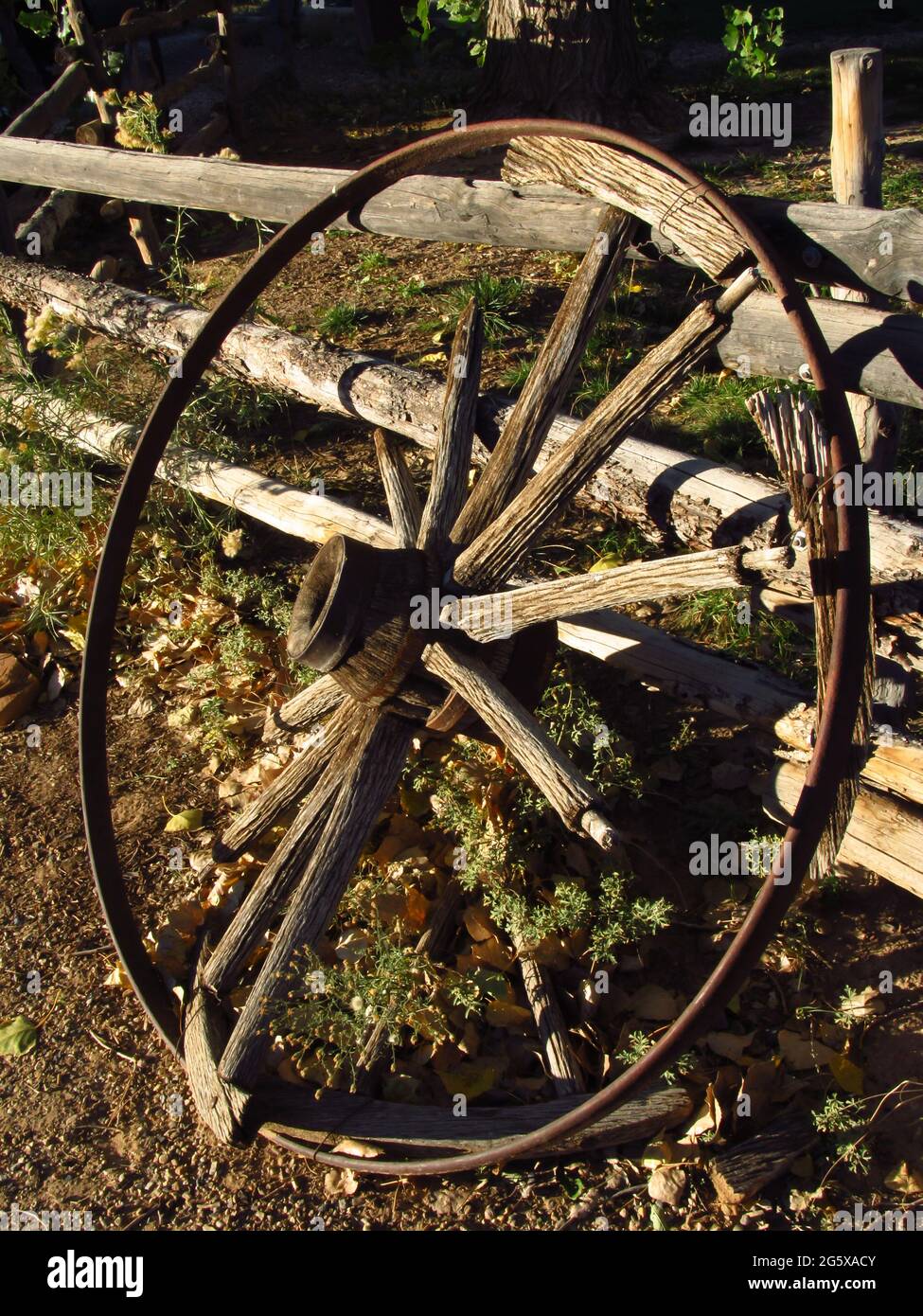An old Broken Wagon wheel in the late afternoon sun in Escalante, Utah USA Stock Photo
