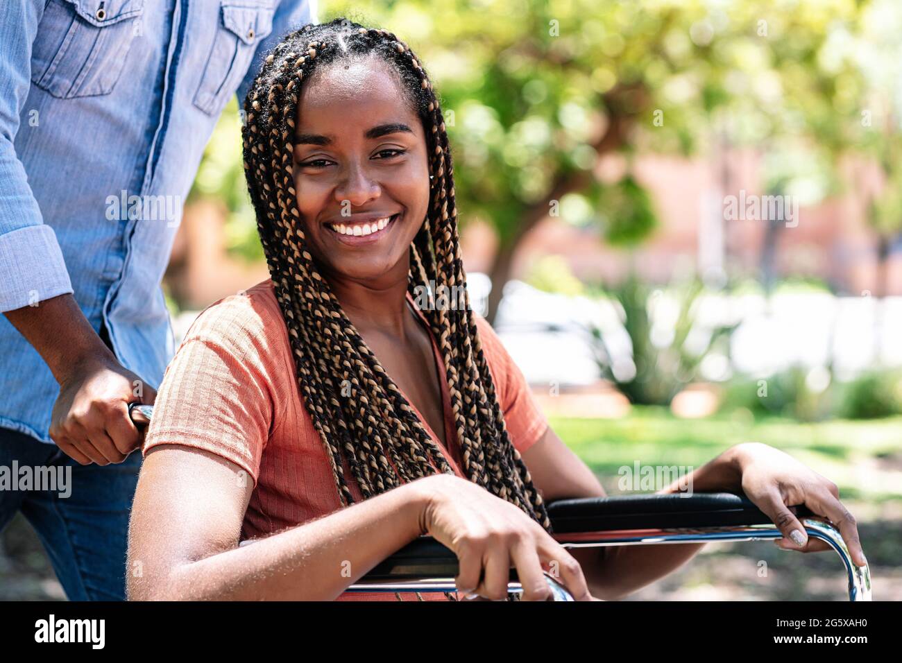 Woman in a wheelchair at the park with her boyfriend Stock Photo - Alamy