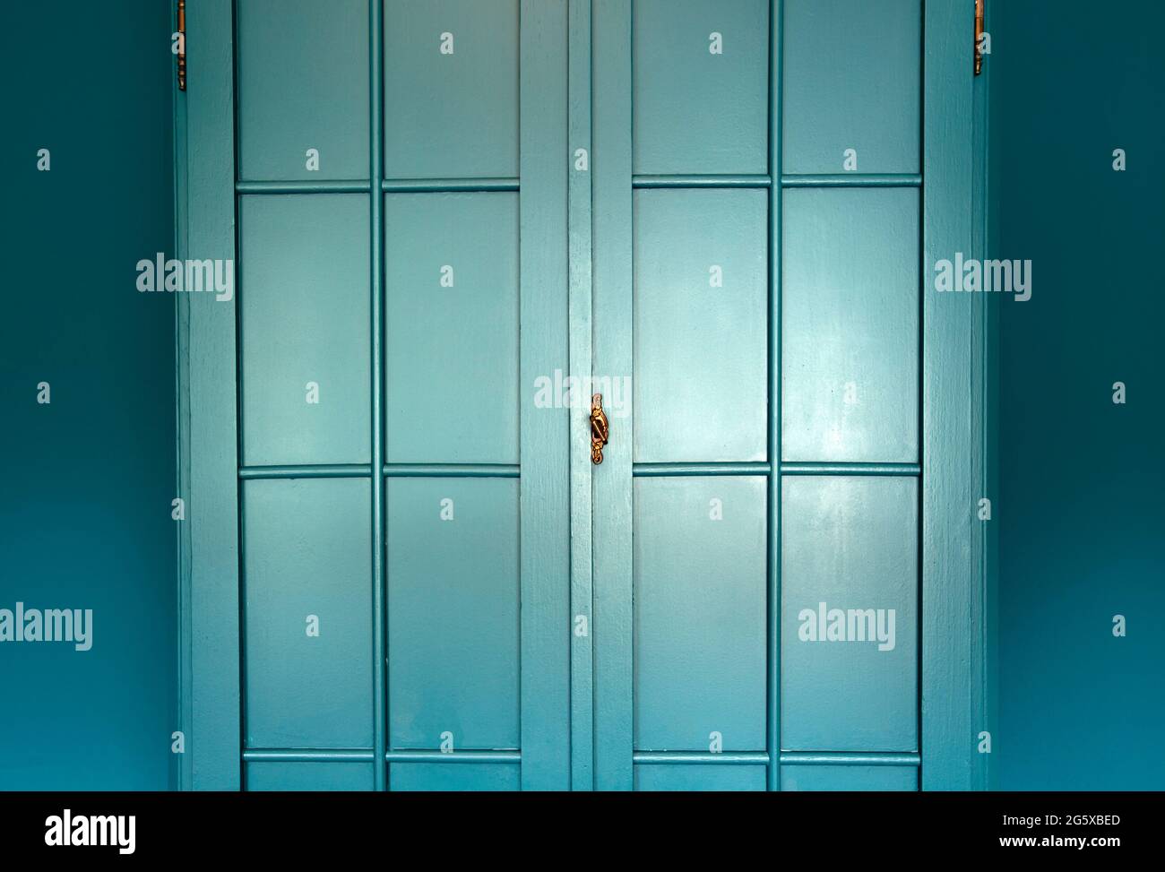 Cyan blue wall with cupboard stylish interior,modern blue cupboard door