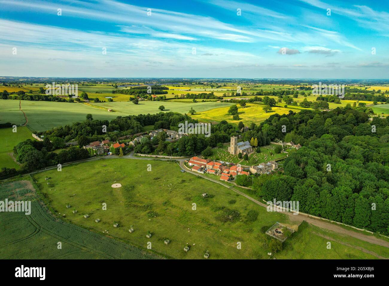 The small village of Hornby, with church and redroofed houses, in