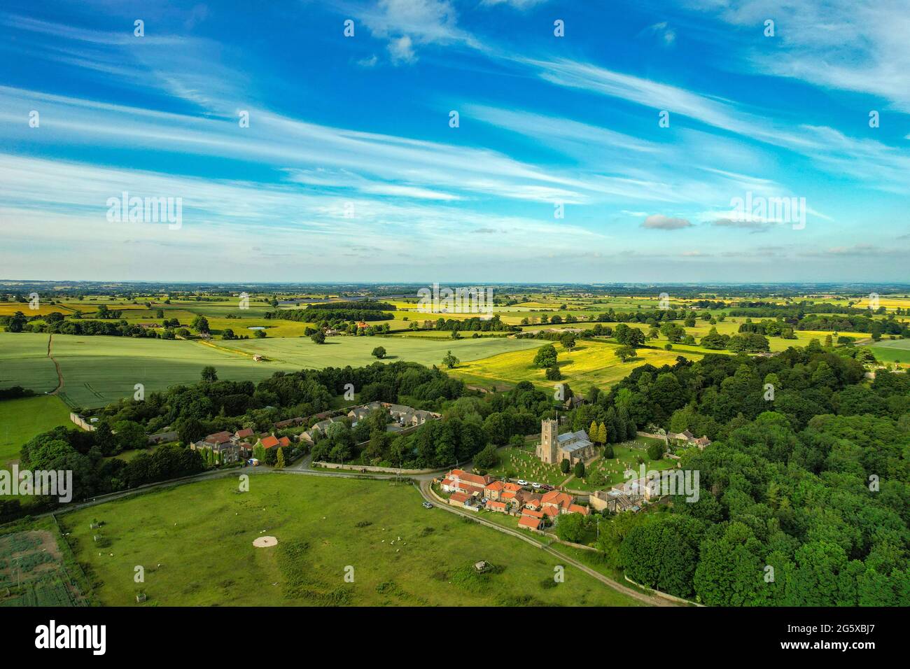 The small village of Hornby, with church and redroofed houses, in rural North Yorkshire