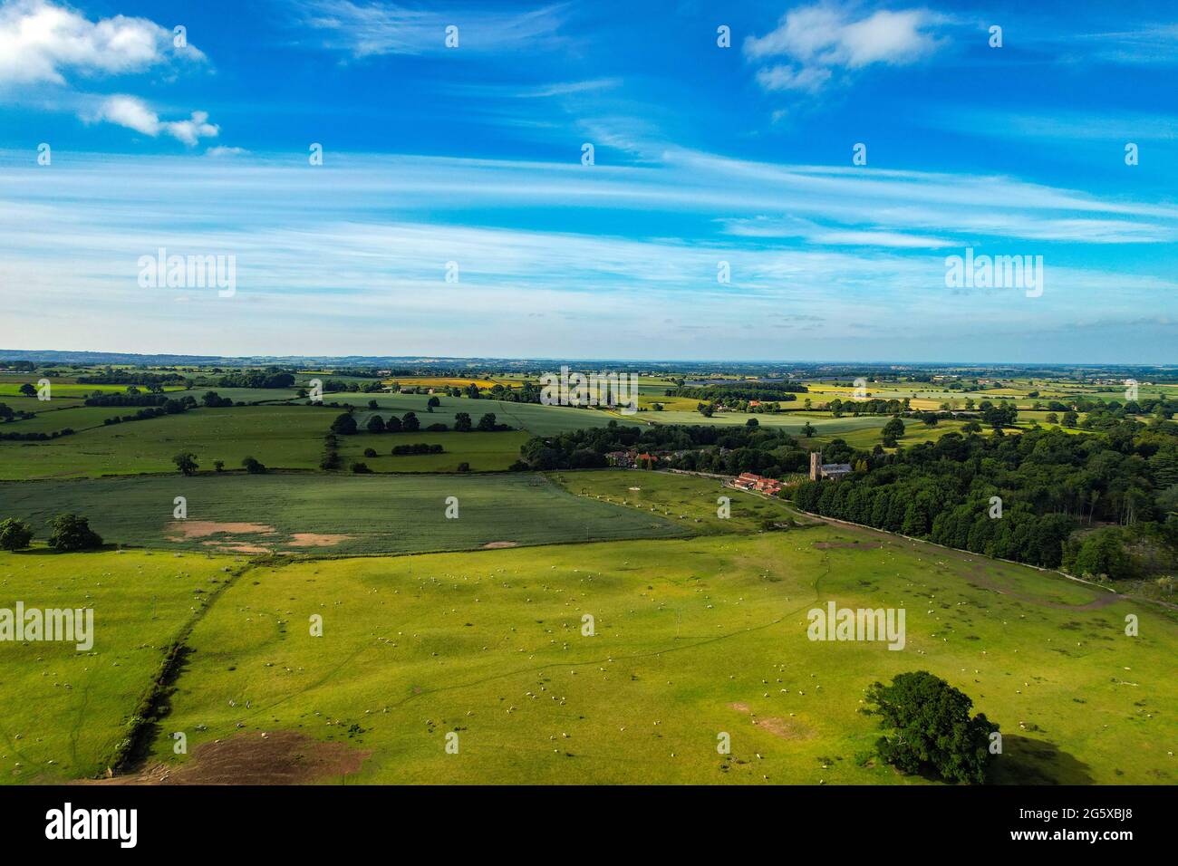 The small village of Hornby, with church and redroofed houses, in