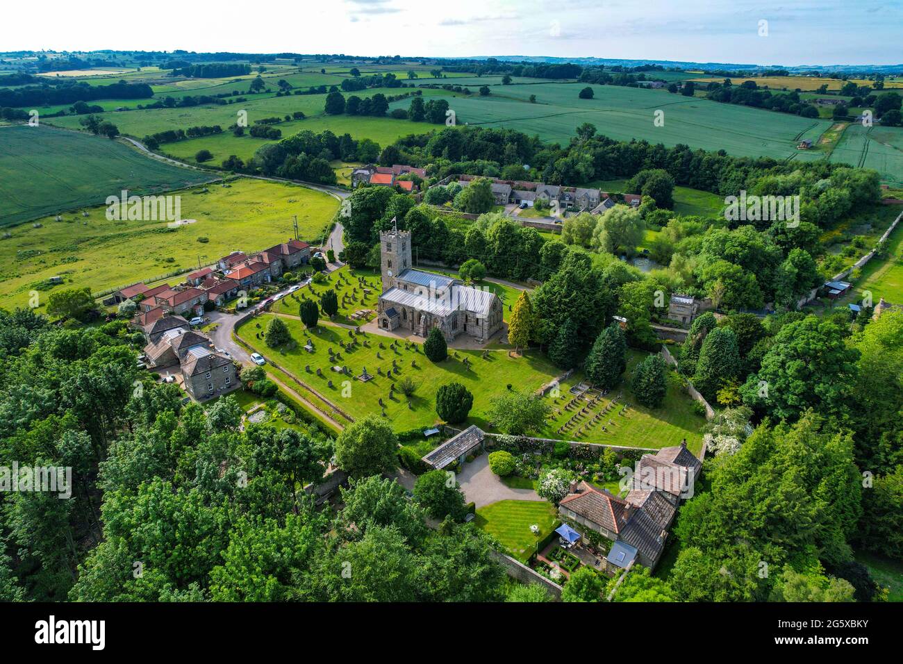 The small village of Hornby, with church and redroofed houses, in rural North Yorkshire