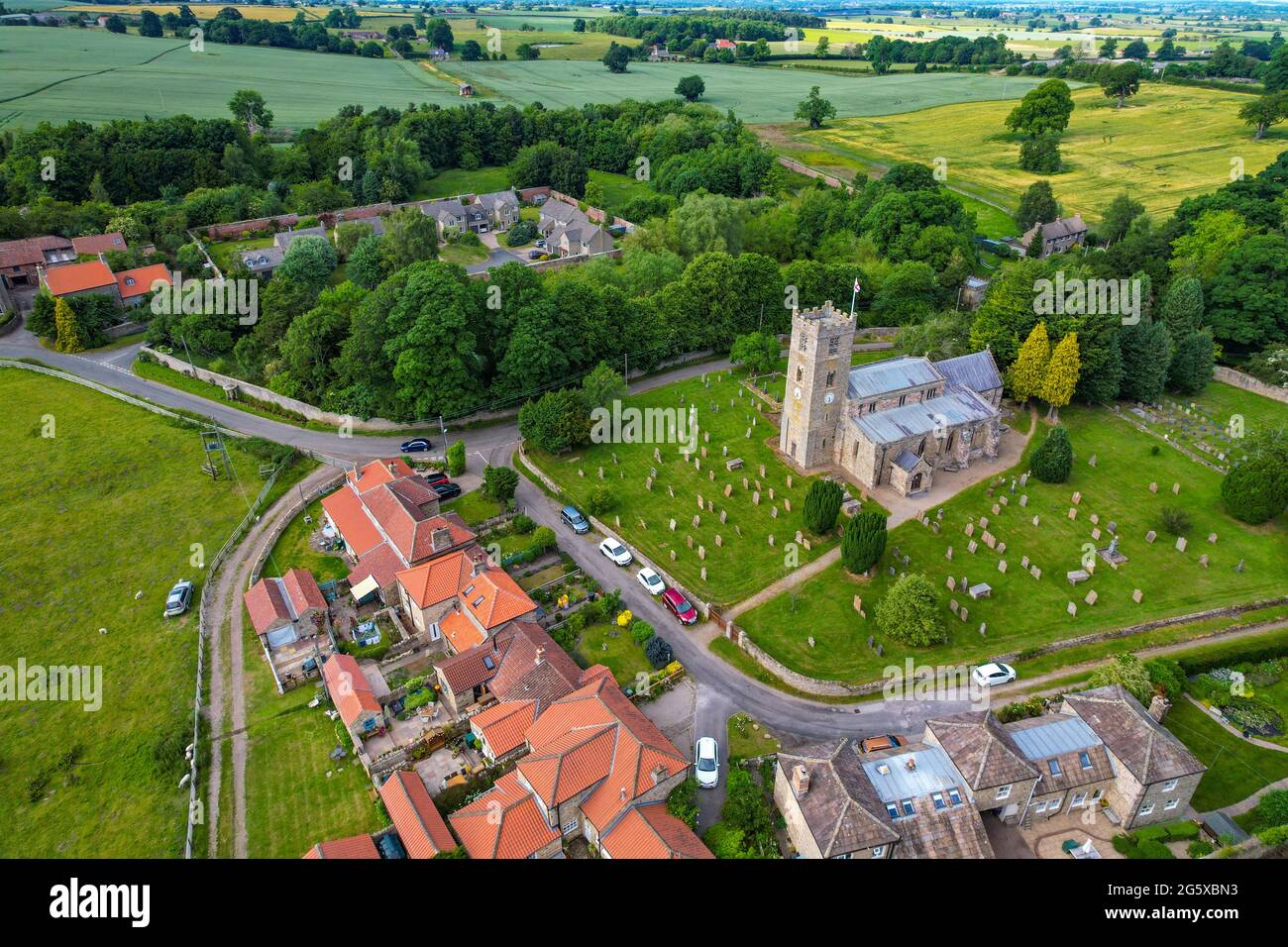 The small village of Hornby, with church and red-roofed houses, in rural North Yorkshire, England, UK Stock Photo