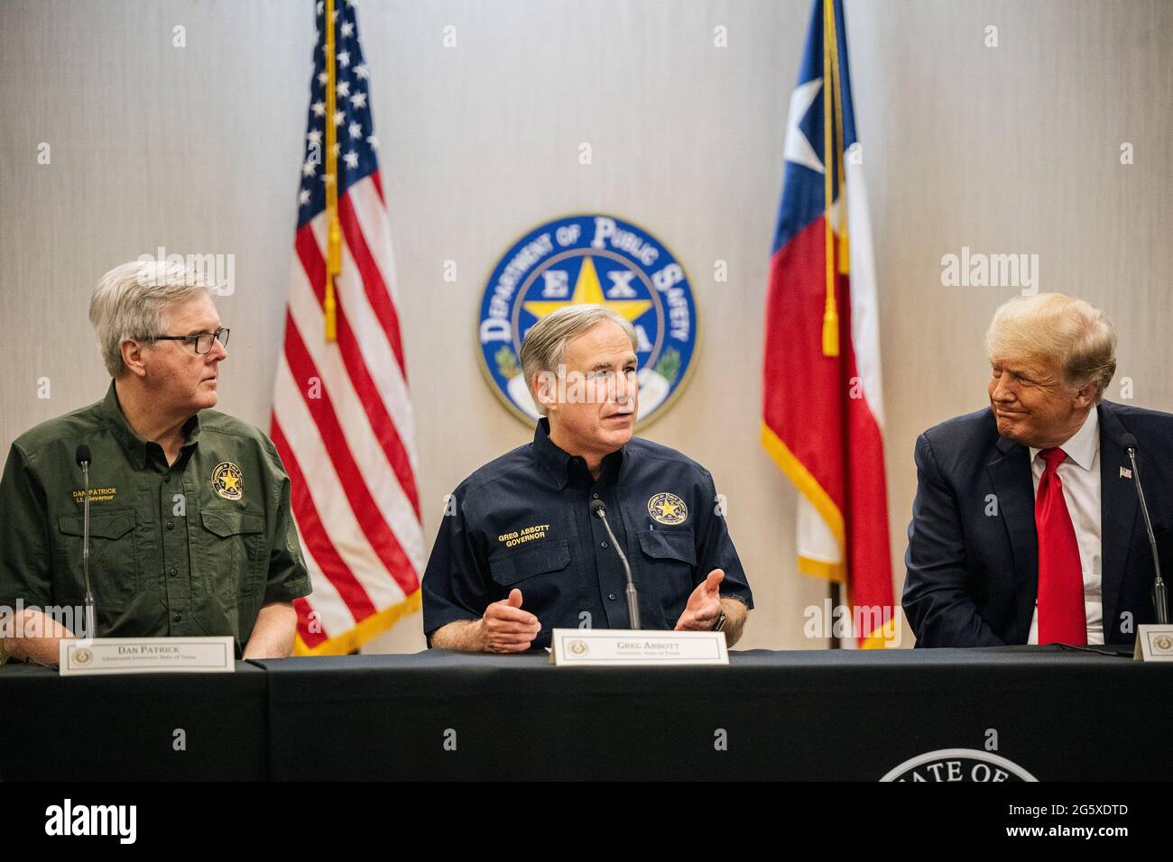 Weslaco Texas USA, June 30: (L-R) Texas Lieutenant Gov. DAN PATRICK, Gov. GREG ABBOTT, and former President DONALD TRUMP attend a border security briefing to discuss further plans in securing the southern border wall. Gov. Abbott has pledged to build a state-funded border wall between Texas and Mexico as a surge of mostly Central American immigrants crossing into the United States has challenged U.S. immigration agencies. (Pool Photo/ Brandon Bell) Credit: Bob Daemmrich/Alamy Live News Stock Photo