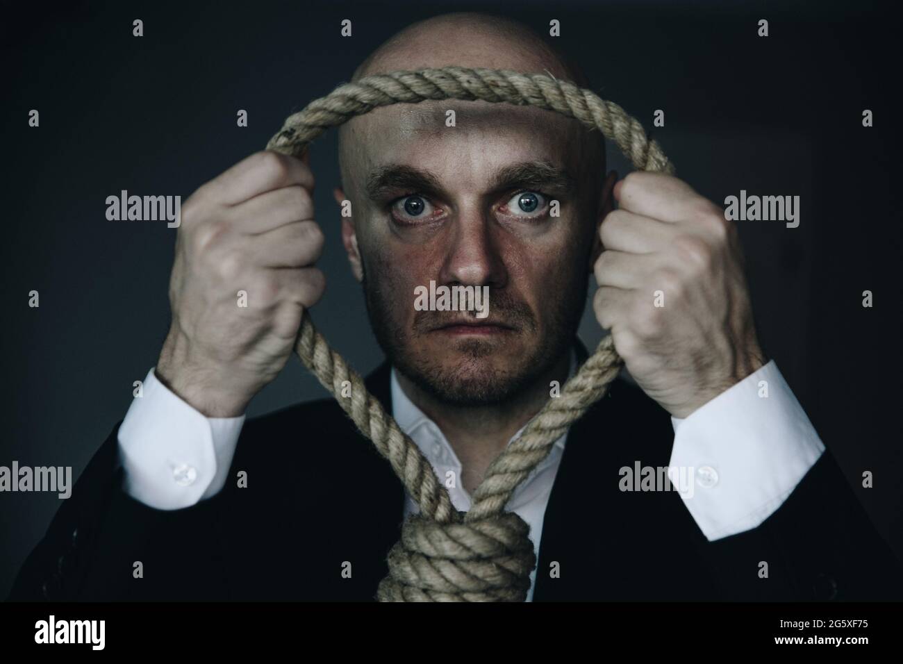 Businessman committing suicide through hanging. Last decision. Stock Photo
