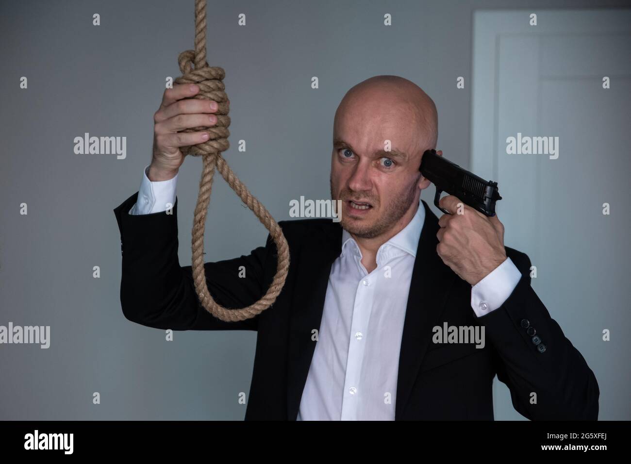 Man in suit commit suicide with a shot in the head. Stock Photo