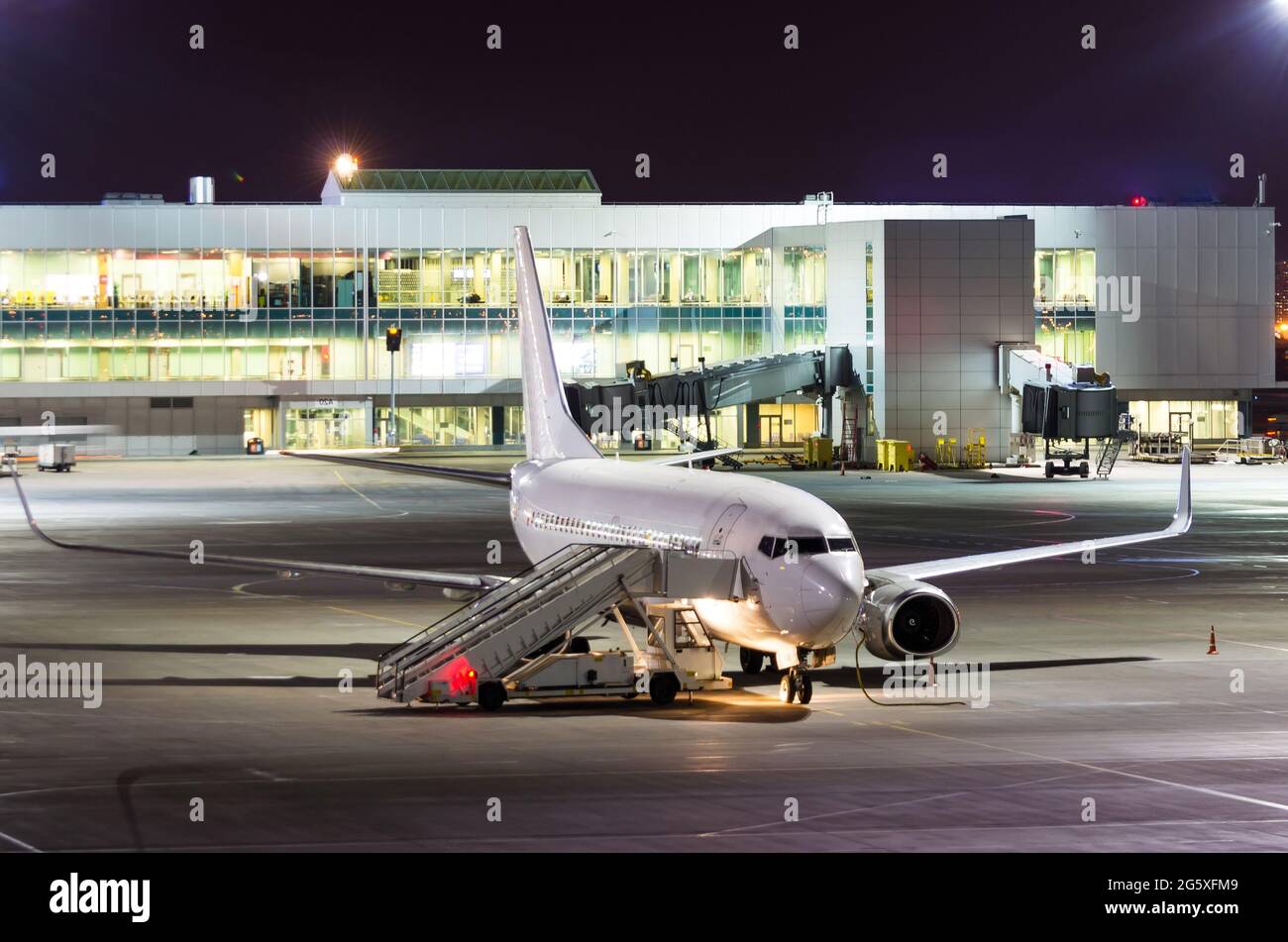 Passenger aircraft parked at night at the airport Stock Photo - Alamy