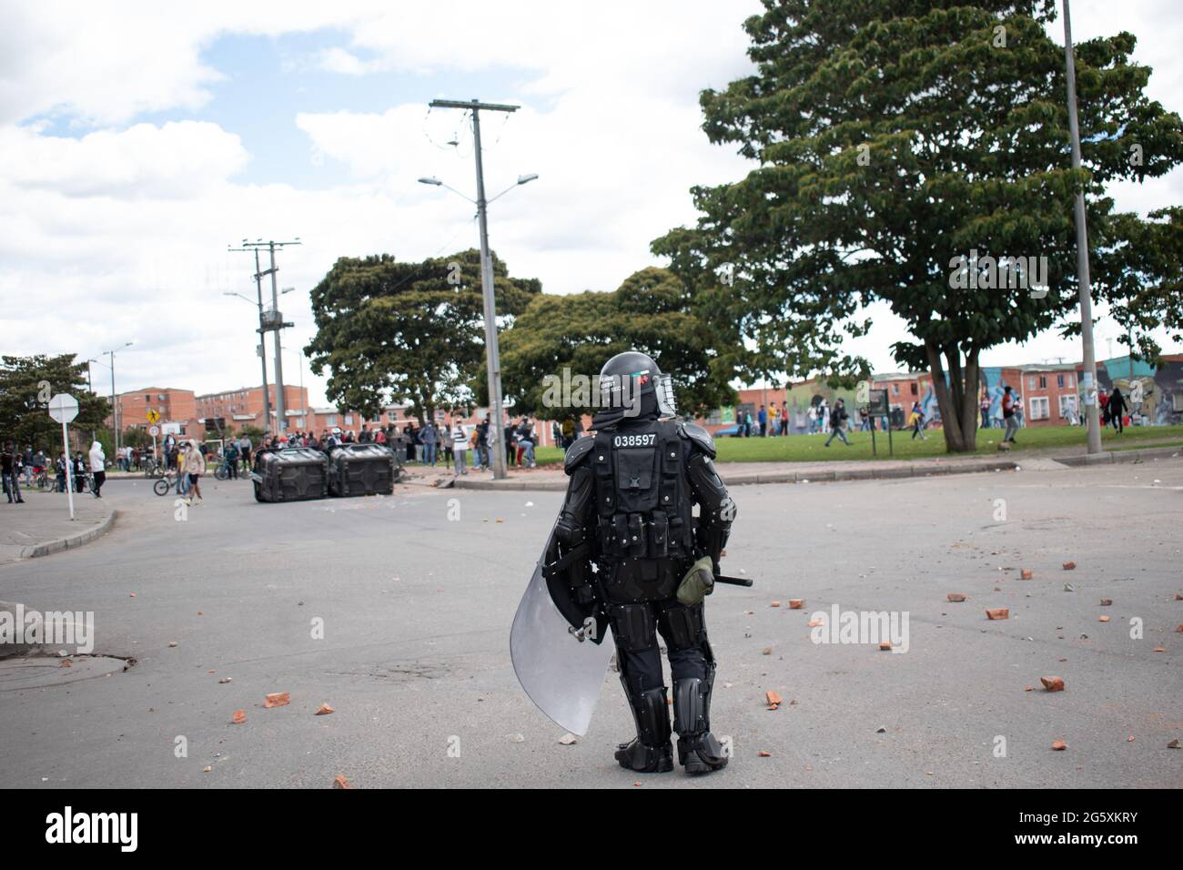 Colombia's riot police officers (ESMAD) use police batons, tear gas canisters and flashbang grendandes, stunt grenades, as people of Fontanar - Suba in Bogota, Colombia protested and clashed against Colombia's riot police (Escuadron Movil Antidisturbios ESMAD) against the visit of Colombia's president Ivan Duque Marquez to a park were Bogota's metro system will be built, amidst two months of anti-government protests against president Ivan Duque Marquez, inequalities and police unrest during the protests, on June 29, 2021. Stock Photo
