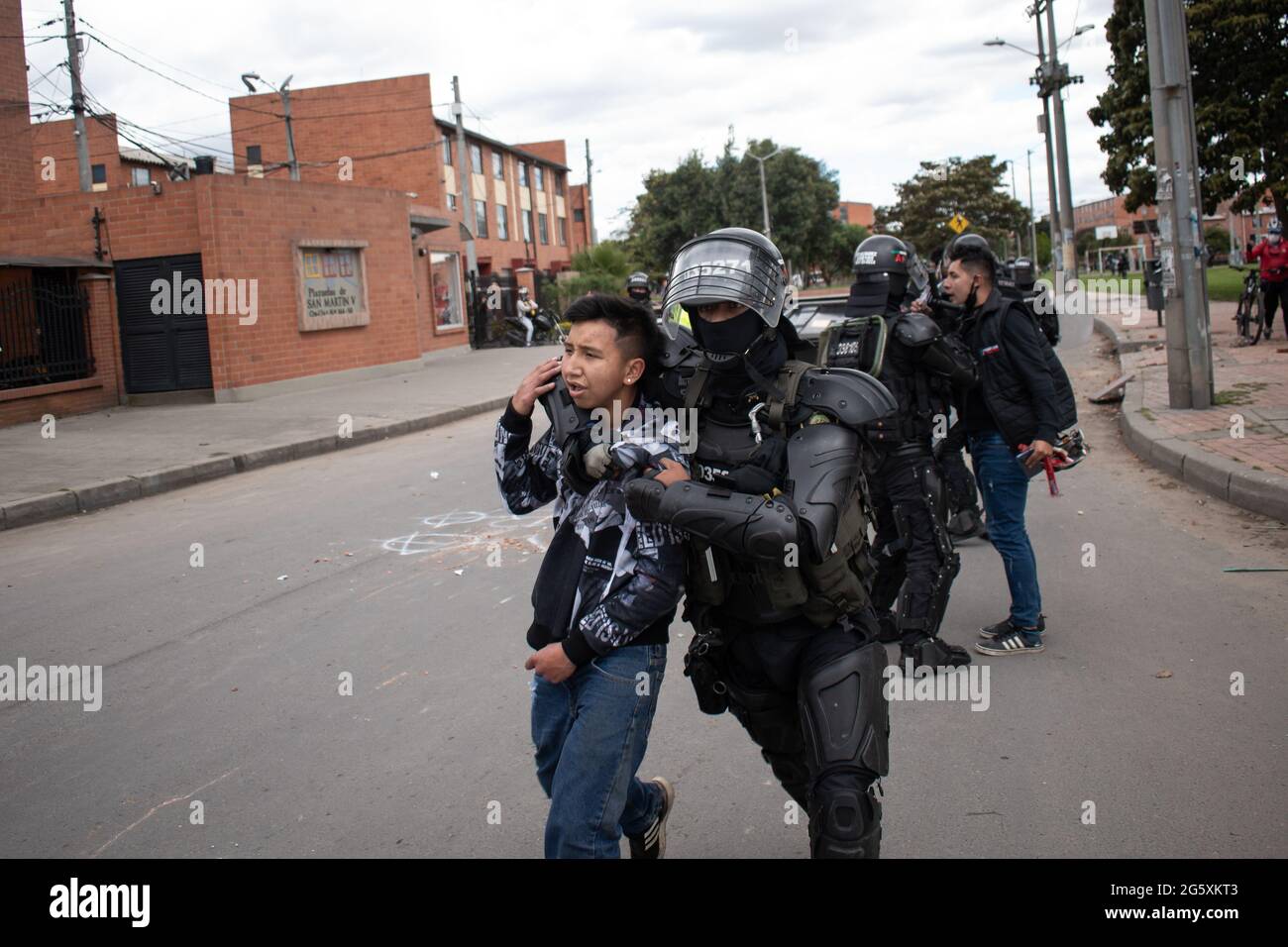 Bogota, Colombia. 29th June, 2021. A demonstrator being arrested by Colombia's riot police (ESMAD) as people of Fontanar - Suba in Bogota, Colombia protested and clashed against Colombia's riot police (Escuadron Movil Antidisturbios ESMAD) against the visit of Colombia's president Ivan Duque Marquez to a park were Bogota's metro system will be built, amidst two months of anti-government protests against president Ivan Duque Marquez, inequalities and police unrest during the protests, on June 29, 2021. Credit: Long Visual Press/Alamy Live News Stock Photo