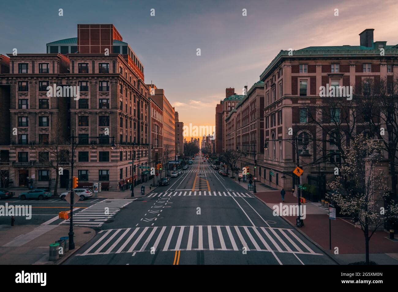 A city street with tall buildings at sunset Amsterdam Avenue from Columbia University, in
