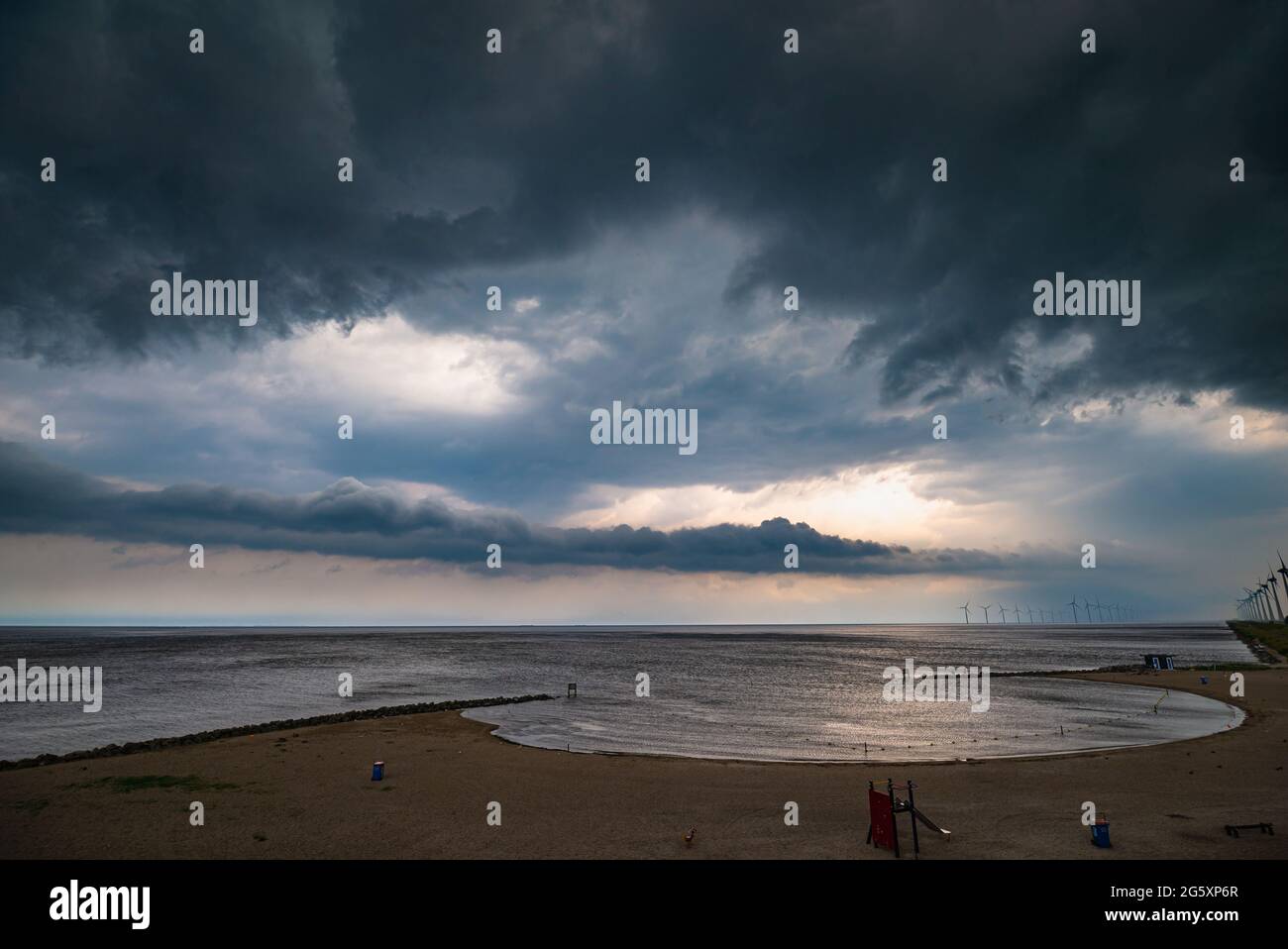 Dark, threatening storm clouds over a lake Stock Photo