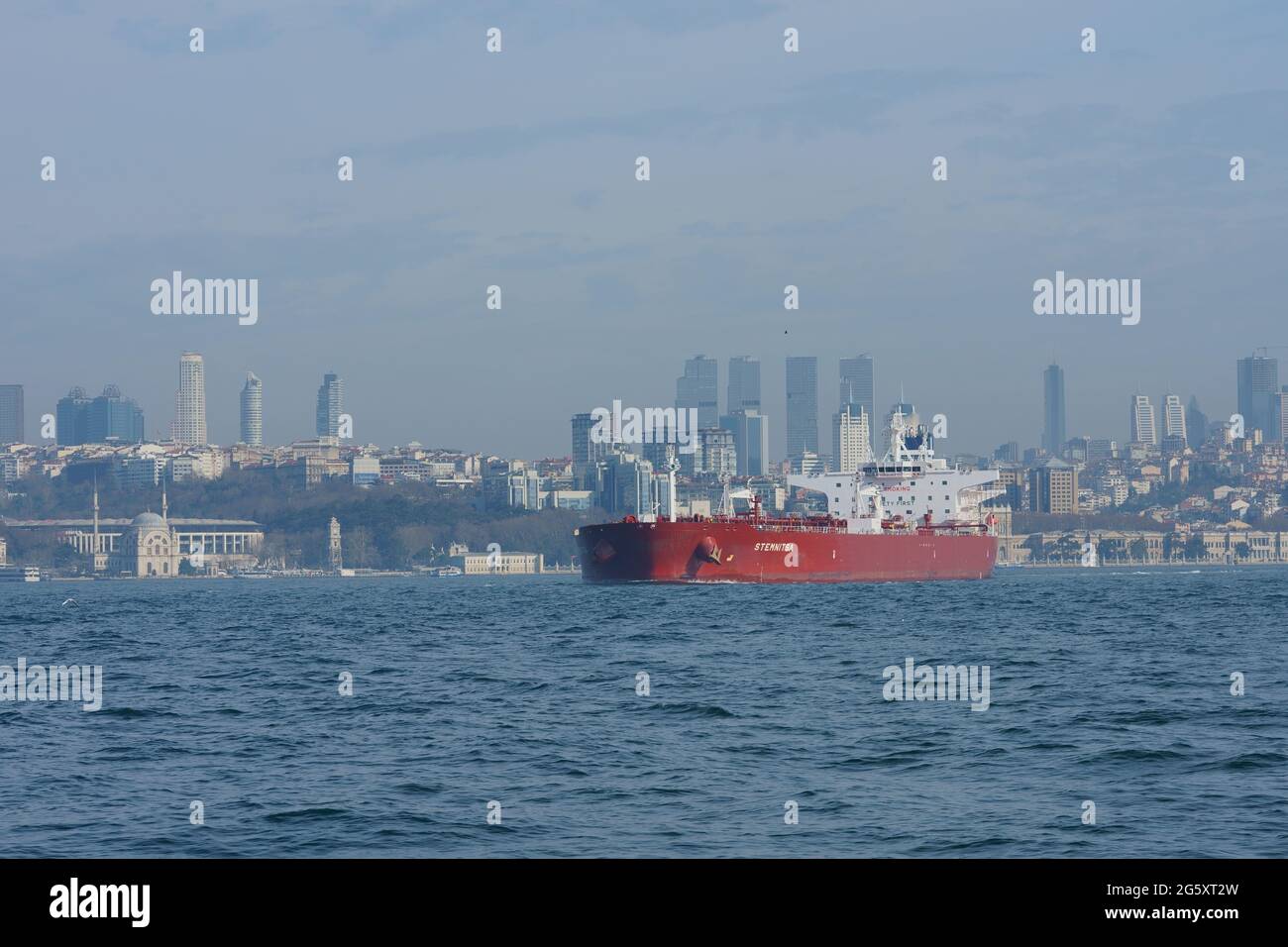 MT, Tanker vessel, ship, sailing at Bosphorus, cityscape at background Stock Photo