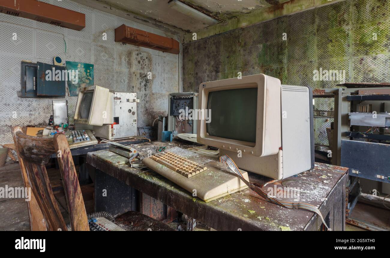 Old computers from the 80s in an abandoned computing center Stock Photo
