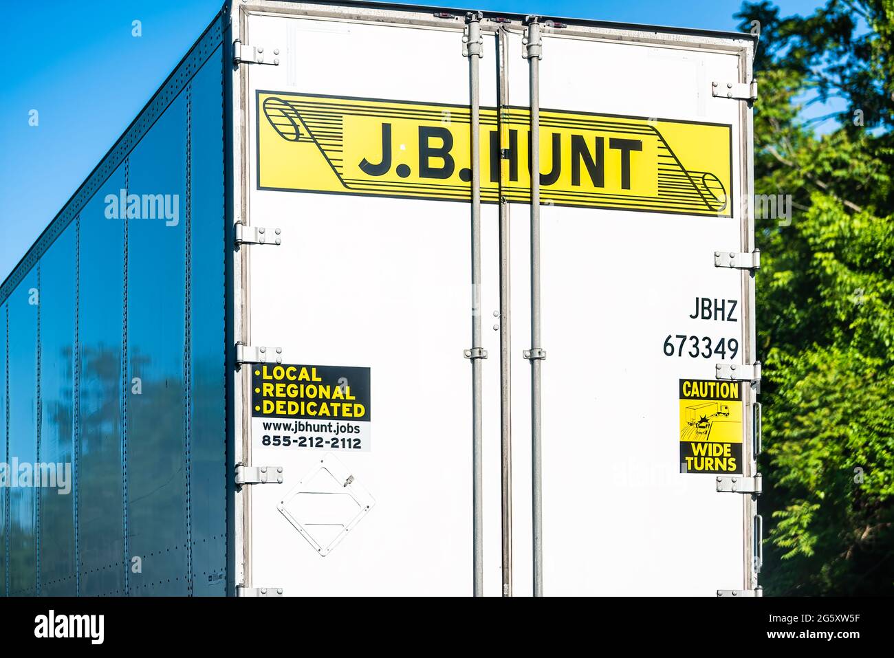 Front Royal, USA - May 27, 2021: Highway road i-66 in Virginia with yellow logo for JB Hunt cargo transportation truck on interstate highway road and Stock Photo