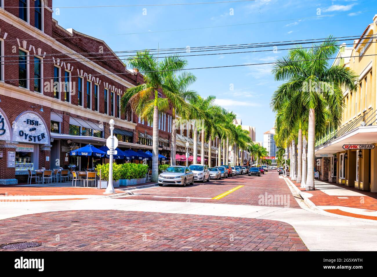 Fort Myers, USA - April 29, 2018: City town main street during sunny day in Florida gulf of mexico coast with shopping and restaurants row palm trees Stock Photo