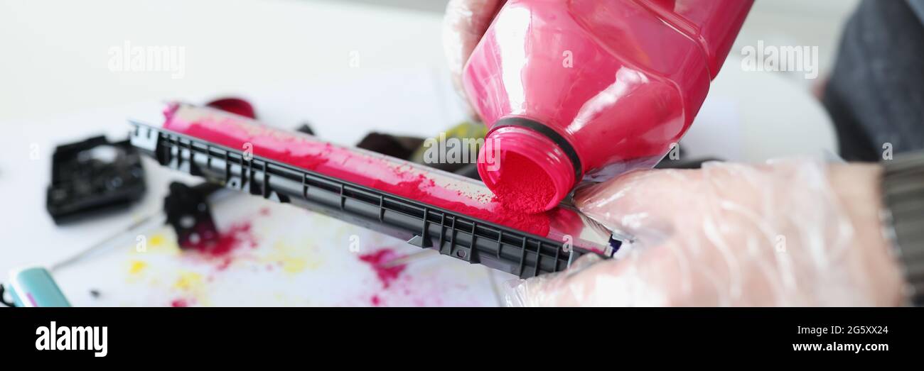 Technician pours red ink into cartridge closeup Stock Photo Alamy