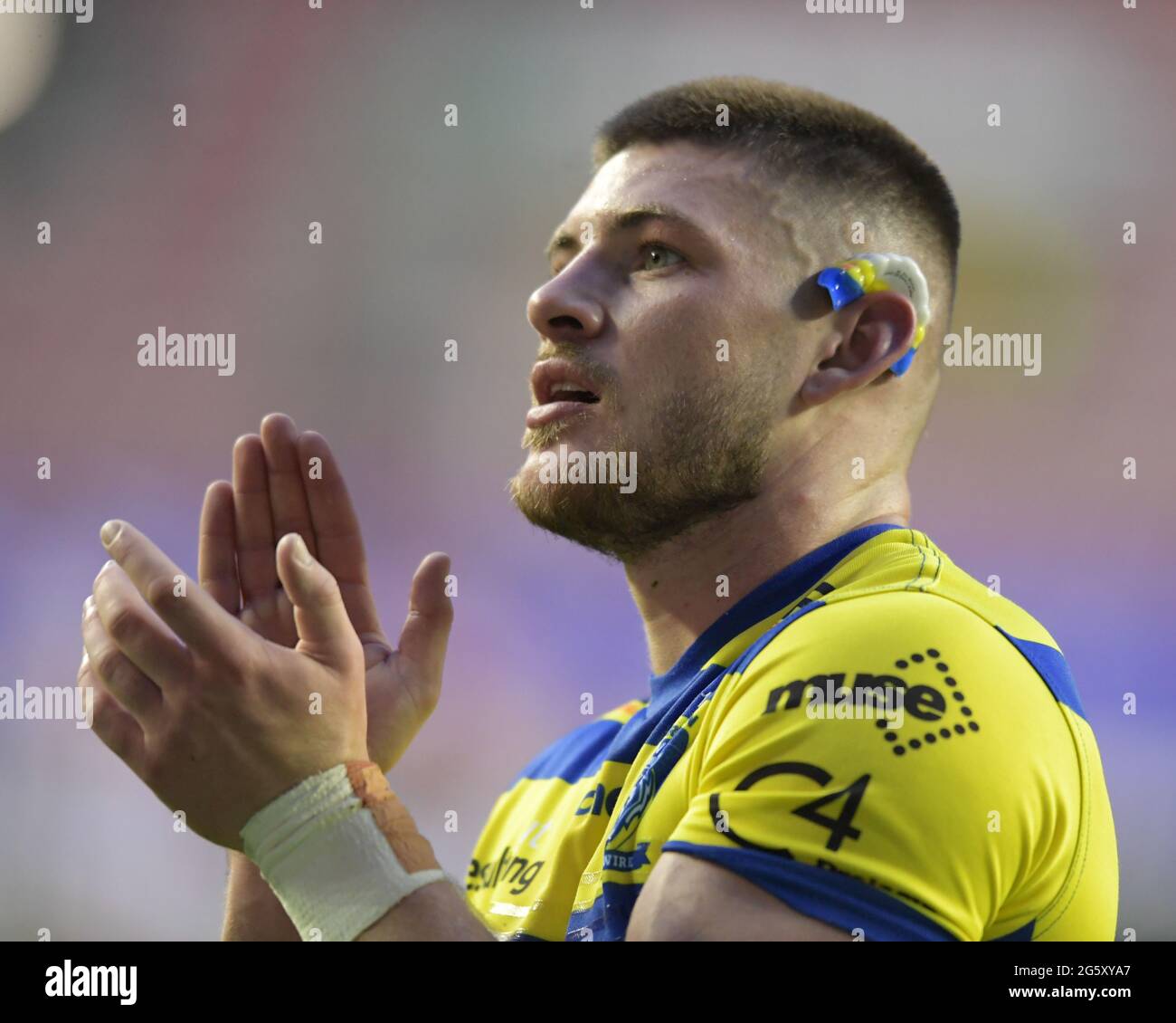 Danny Walker (16) of Warrington Wolves applauds the travelling