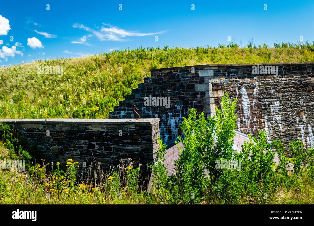the corner walls of the fort with a grass mound on top Stock Photo