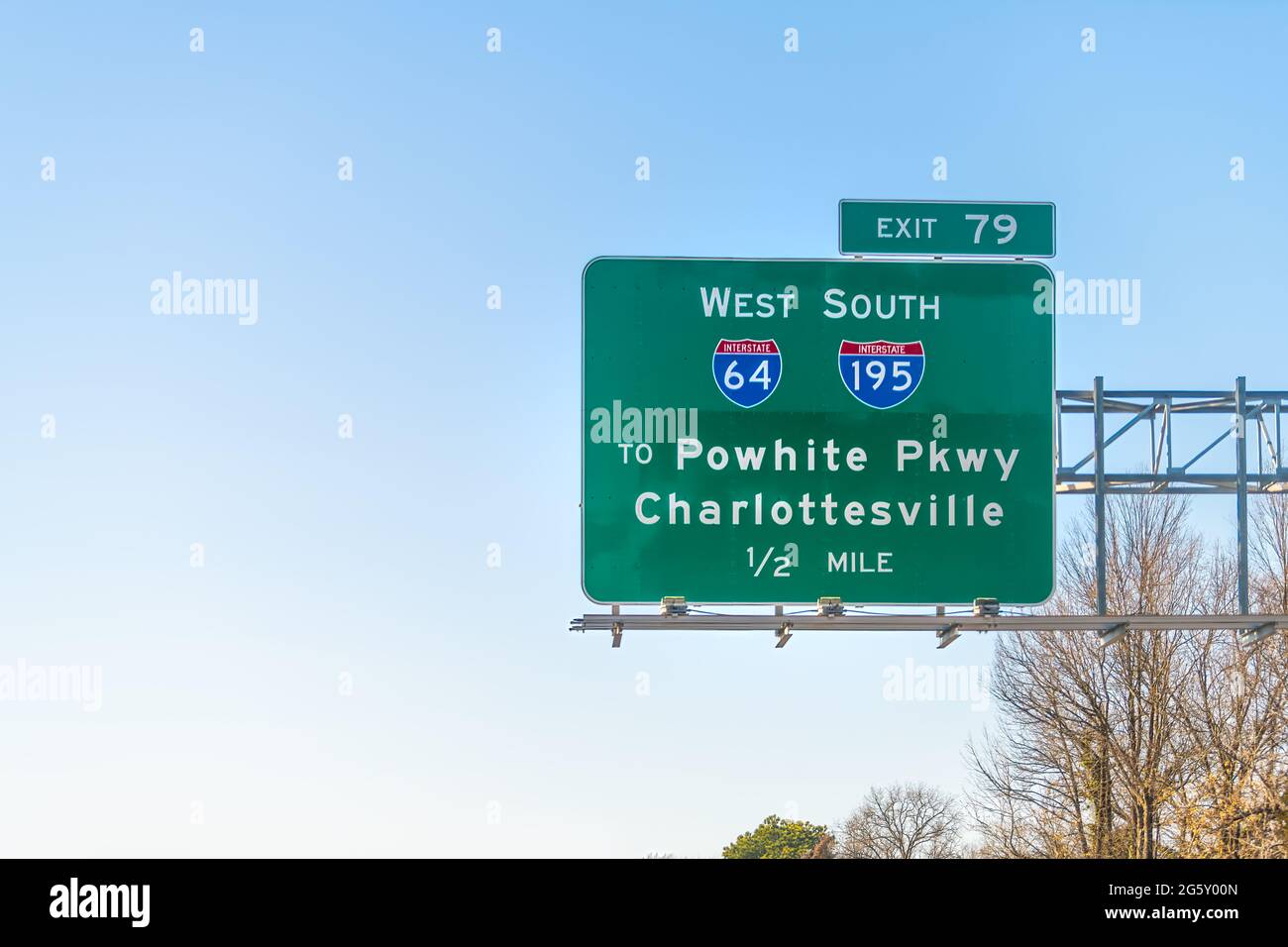 Richmond, USA - March 5, 2021: Sign on i95 interstate 95 highway in Virginia for way exit to Charlottesville via interstate 64 and blue sky Stock Photo