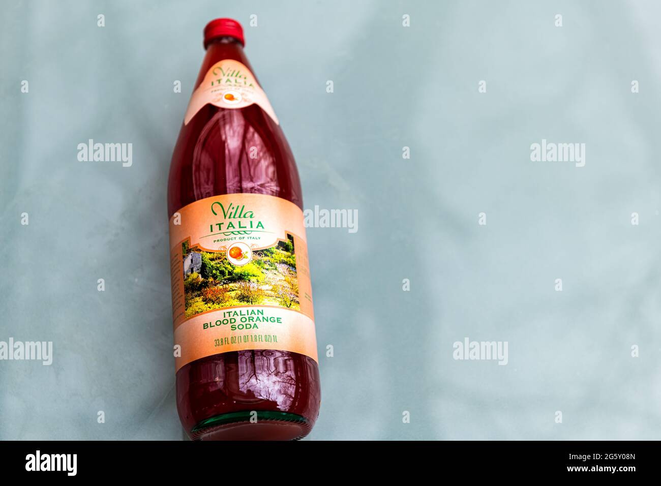 Nellysford, USA - April 29, 2021: Closeup of glass Italian drink bottle carbonated blood orange soda storebought at Trader Joe's and sign isolated Stock Photo