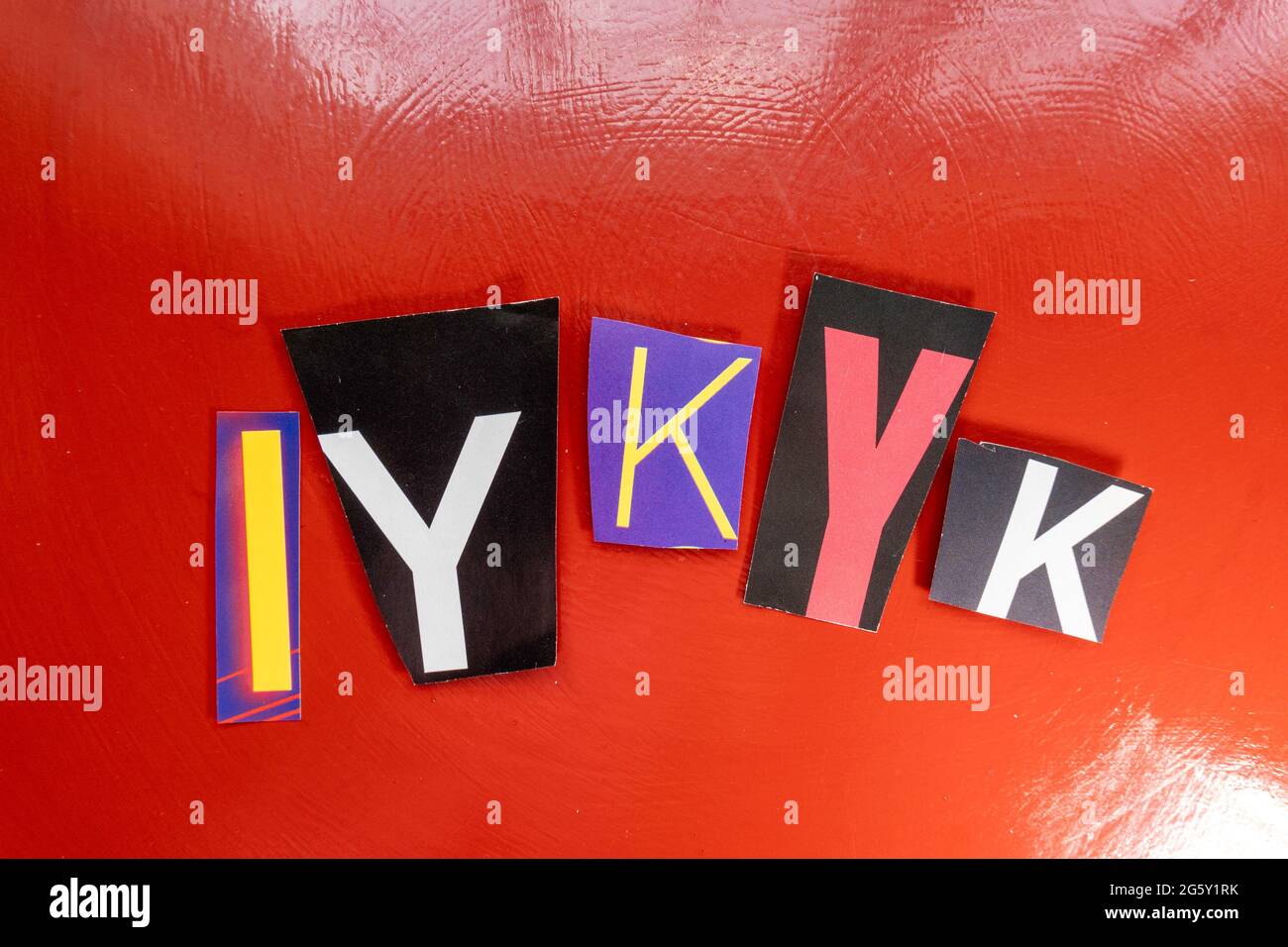 The acronym IYKYK is short for "If You Know You Know" and is spelled out in ransom note style typography, USA Stock Photo