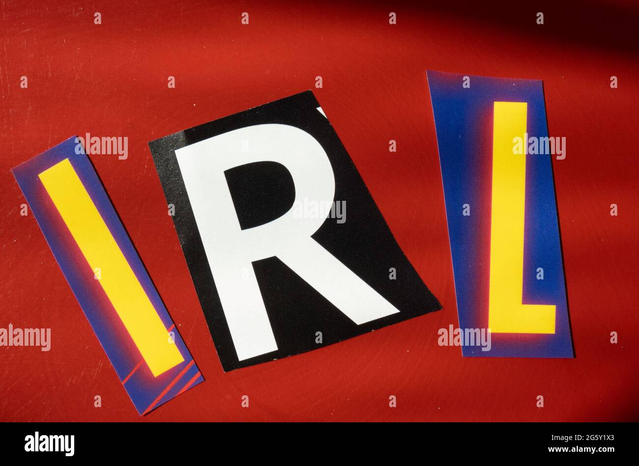 The acronym IRL is short for 'In Real Life' and is spelled out in ransom note style typography, USA Stock Photo