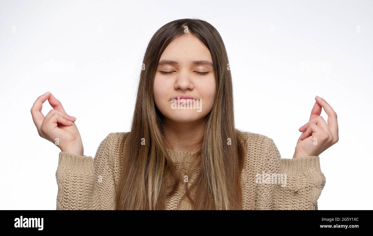Angry girl controlling her emotions and breathing deeply to calm down