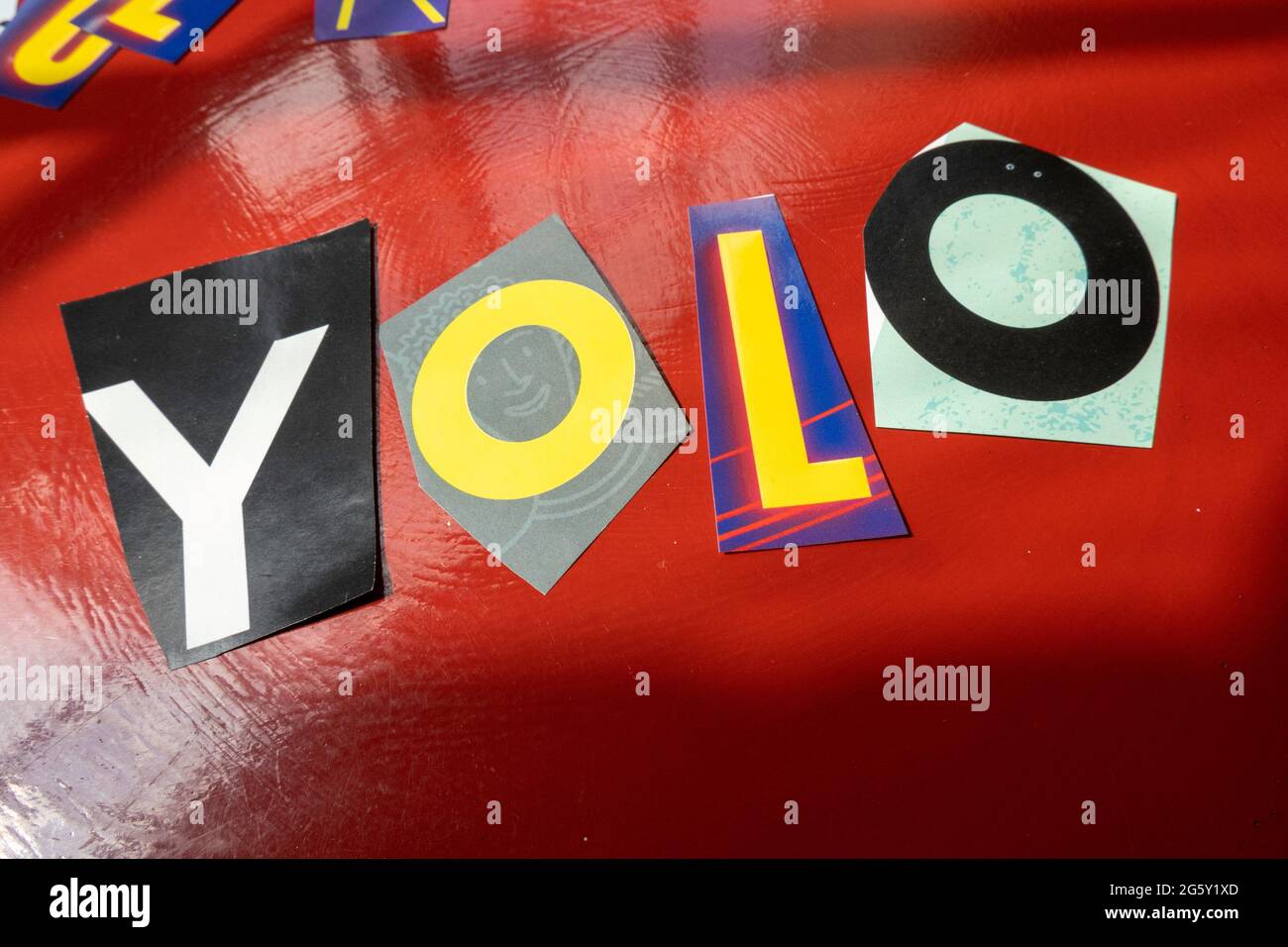 The acronym YOLO is short for 'You Only Live Once' and is spelled out in ransom note style typography, USA Stock Photo