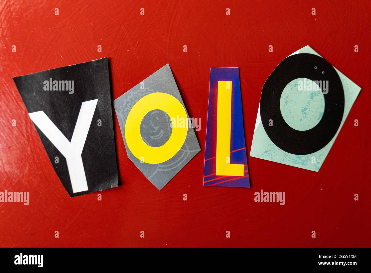 The acronym YOLO is short for 'You Only Live Once' and is spelled out in ransom note style typography, USA Stock Photo