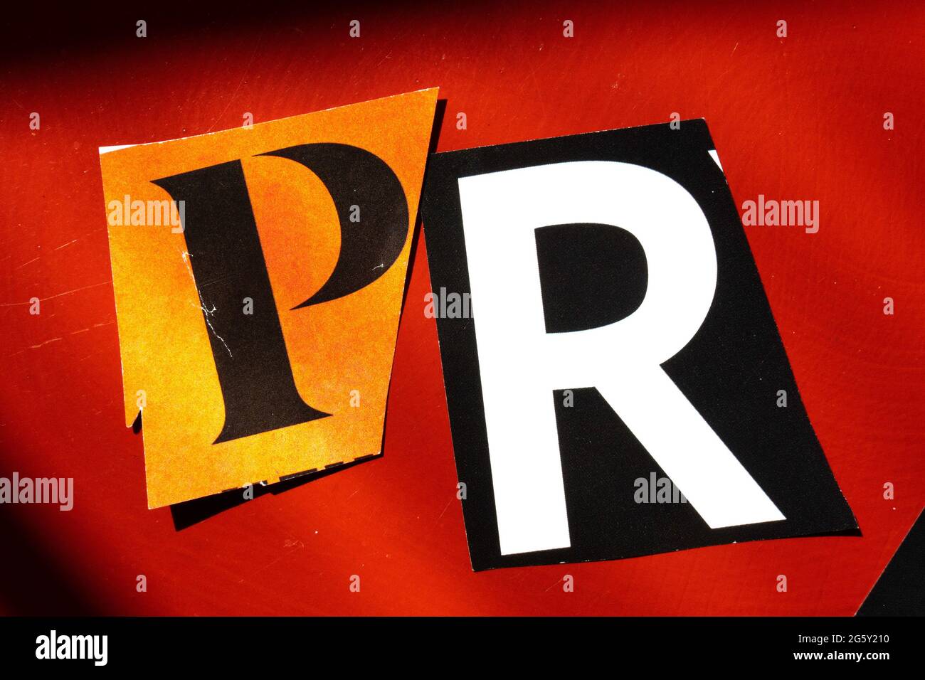 The acronym PR is short for 'Public Relations' and is spelled out in ransom note style typography, USA Stock Photo