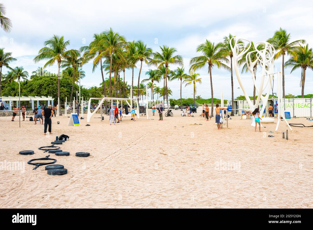 Miami Beach, USA - January 17, 2021: South beach gym with muscular men working out at outdoor fitness station, Muscle Beach, and Lummus Park promenade Stock Photo