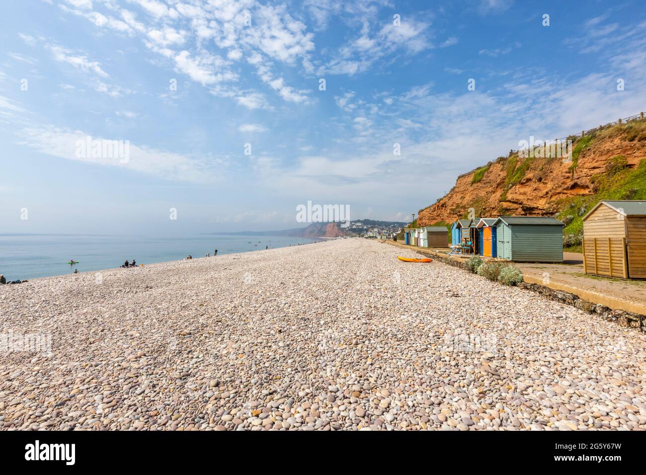 Pebble beach and colourful huts under cliffs in Budleigh Salterton, a