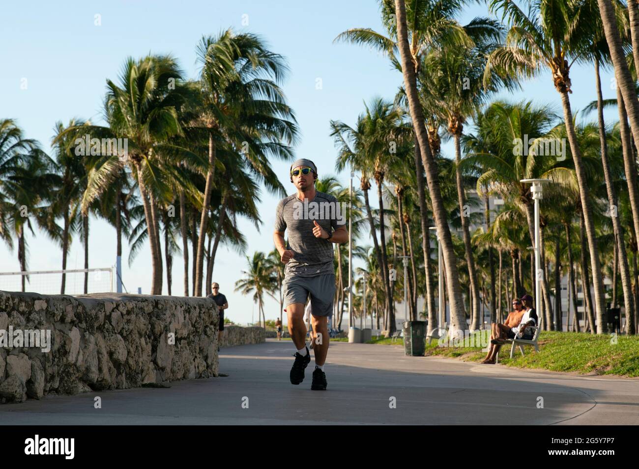 People exercising on the pathway running along the edge of South Beach in Miami, Florida Stock Photo